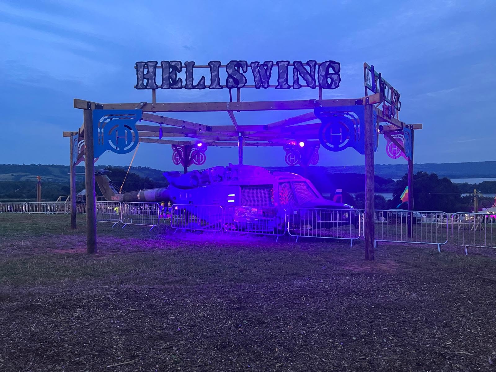 HELISWING lit in purple and pink at dusk at Valley Fest