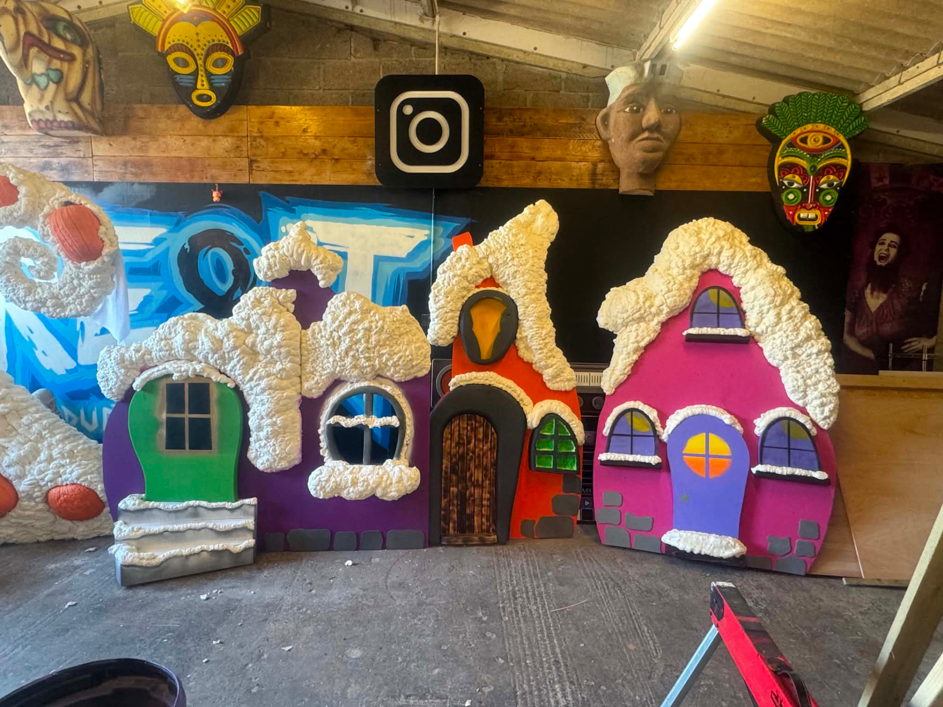 Painted Whoville house facades with sculpted snow-capped roofs